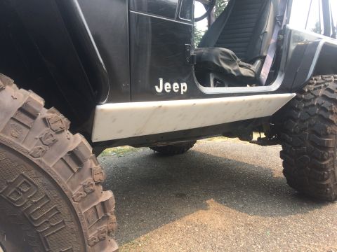 1995 Jeep Wrangler - 1995 Jeep YJ side view showing rocker protection and off-road tires.