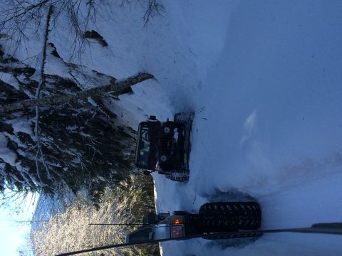1995 Jeep Wrangler - Two off-road vehicles are seen driving on a snow-covered path during winter.