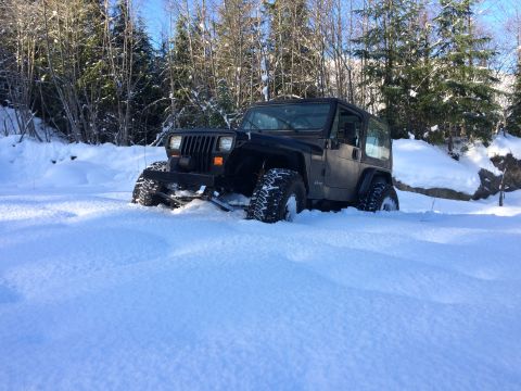 1995 Jeep Wrangler - 1995 Jeep YJ navigating a snowy trail with deep drifts.