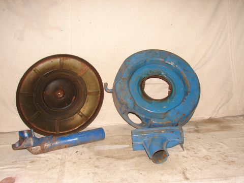 1973 Ford Ranchero - Several blue-painted air cleaner components are laid out on a white surface.