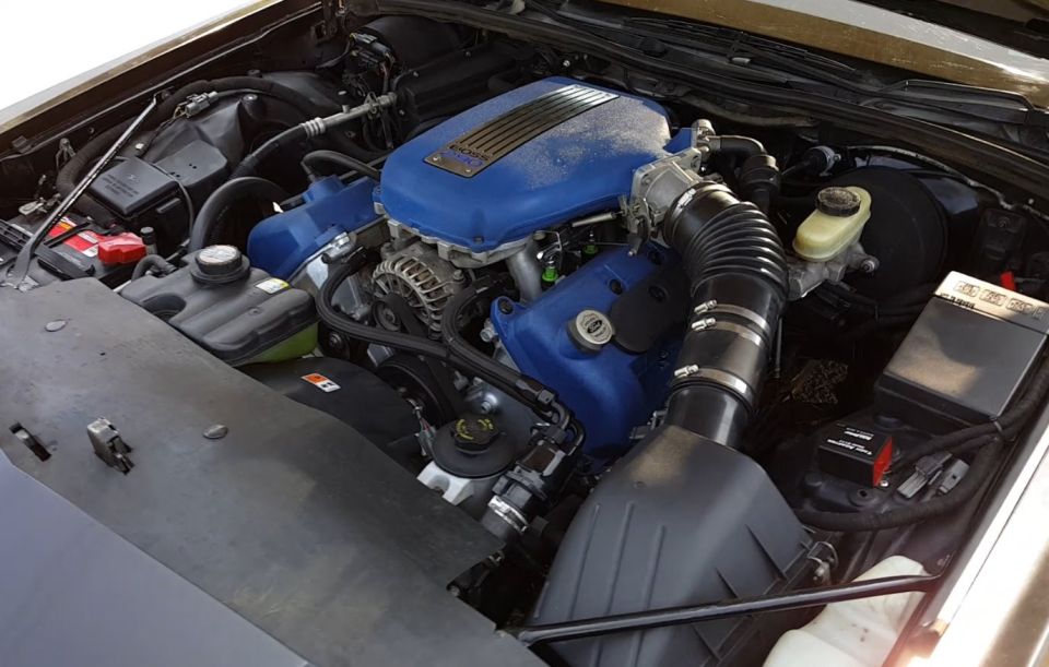 Engine bay with blue intake manifold and air intake system