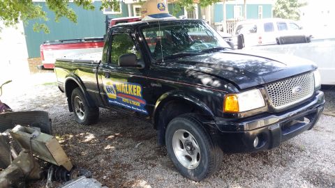2003 Ford Ranger - Dent in the door needs to be pulled. Wonder what the paint looks like underneath that sticker..