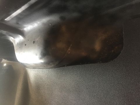 1978 Ford Bronco - Close-up view of the underside of a vehicle component, showing its shape and texture.