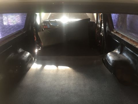 1978 Ford Bronco - View from the back of a vehicle's interior, showing the cargo space and the front cabin area.