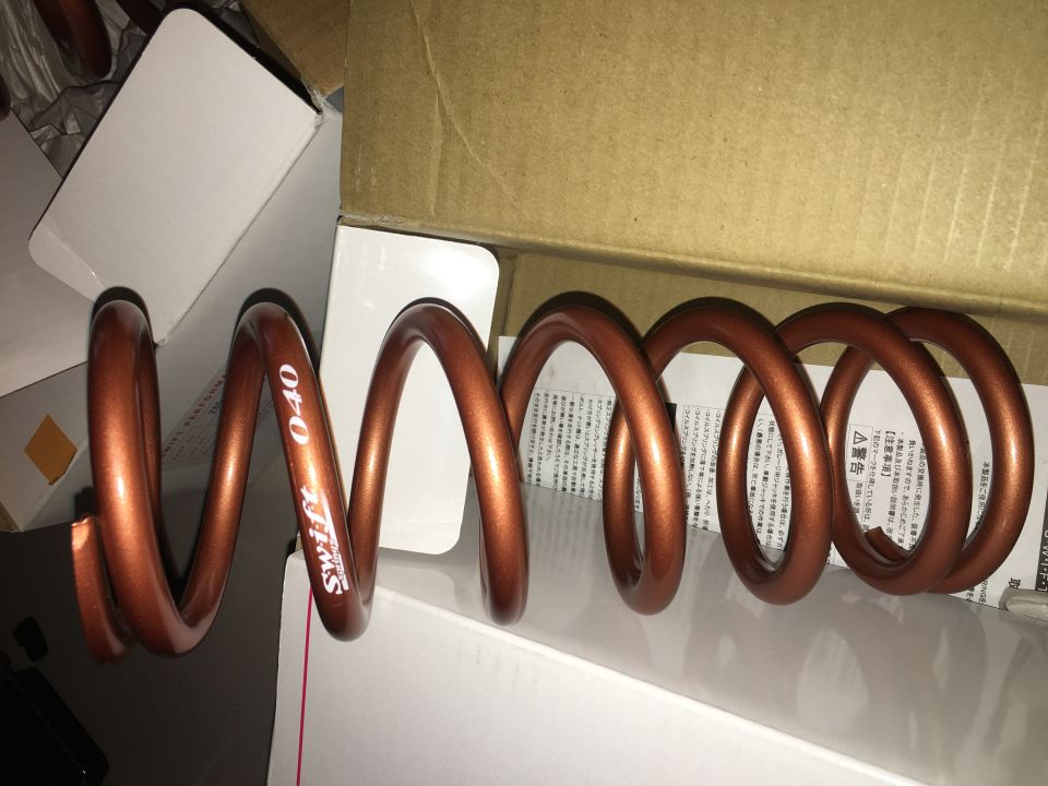 Copper-colored Swift coil spring with '040' marking