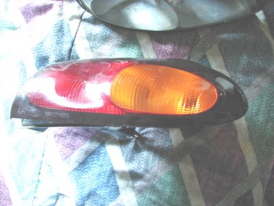 1997 Ford Taurus - This taillight assembly features distinct red and amber sections, likely for a vehicle part replacement.