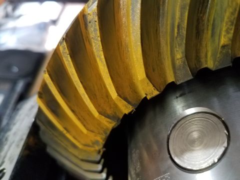 1995 Ford Bronco - A close-up view of a worn ring and pinion gear, likely from a differential assembly.