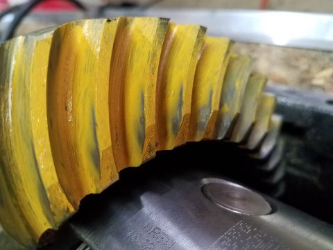 1995 Ford Bronco - Close-up of a yellow ring and pinion gear, showing signs of wear.