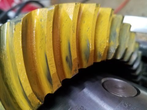 1995 Ford Bronco - Close-up of a yellow ring gear, showing teeth and some wear. Text from the source website is visible at the bottom.