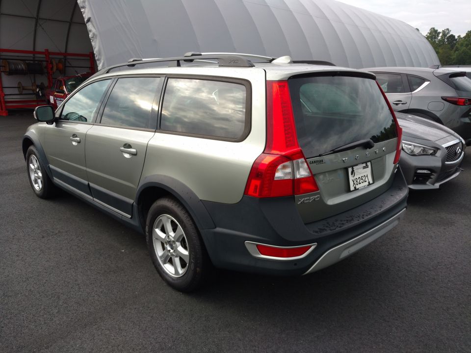 Silver Volvo XC70 wagon parked next to an Infiniti sedan