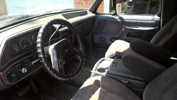 1990 Ford Bronco interior showing dashboard, steering wheel, and front seats