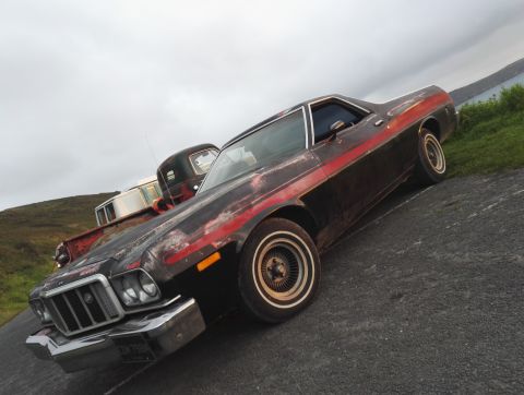 1974 Ford Ranchero - This 1974 Ford Ranchero shows significant wear on its paint, with a prominent red stripe along the side.