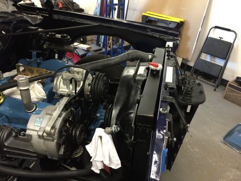 2001 Ford Crown Victoria - Close-up view of a vehicle's engine bay, focusing on the radiator and alternator assembly.