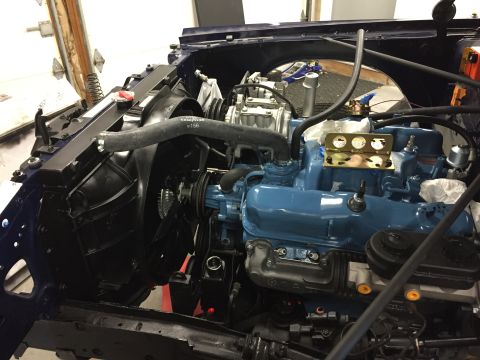 2001 Ford Crown Victoria - Close-up view of a blue engine, radiator, and fan assembly in a vehicle's engine bay.
