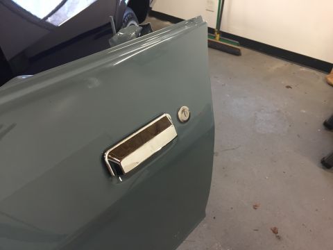 2001 Ford Crown Victoria - Close-up of a car door panel, showing the exterior door handle and lock mechanism.