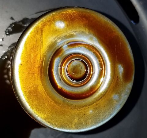 2000 Ford Crown Victoria - Close-up of an oil filter showing amber-colored fluid, with a watermark for Supermotors.net at the bottom.