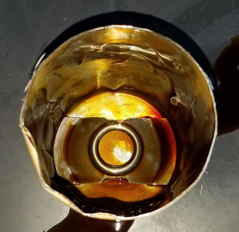 2000 Ford Crown Victoria - A used oil filter shows significant dark oil residue, indicating potential engine issues or a need for replacement.