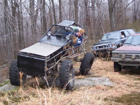 1978 Ford Bronco - Multiple off-road vehicles gathered in a wooded area during an outing.