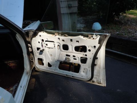 2001 Ford Crown Victoria - The interior of a car door is exposed, revealing its internal components and structure.