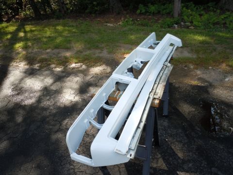 2001 Ford Crown Victoria - A disassembled car bumper and grille assembly is shown outdoors, resting on sawhorses.