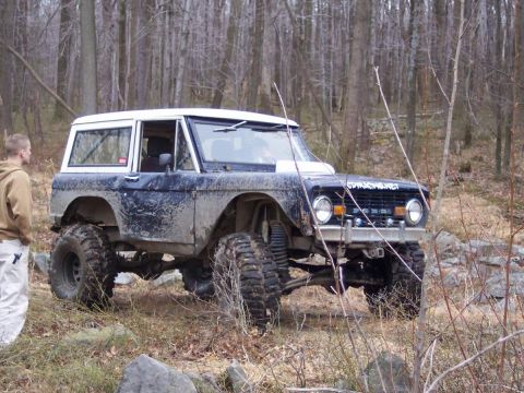 1978 Ford Bronco - This lifted 1978 Ford Bronco navigates a rocky, wooded trail, its off-road capabilities.