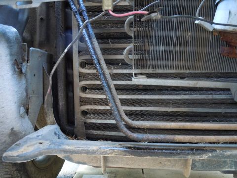 2001 Ford Crown Victoria - The AC condenser unit is visible, showing its fins and connected hoses.