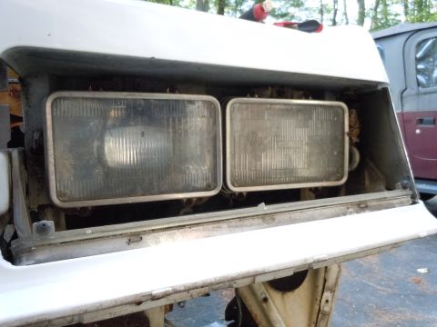 2001 Ford Crown Victoria - Close-up view of the removed headlights from a vehicle, showing the internal structure and lenses.