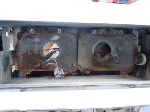 2001 Ford Crown Victoria - Close-up of corroded headlight assemblies, showing internal components and wiring.