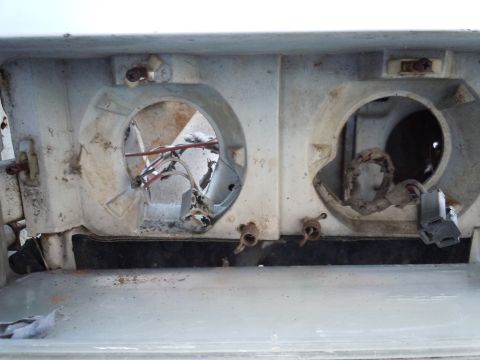 2001 Ford Crown Victoria - Close-up of a damaged headlight housing, showing exposed wiring and empty sockets.