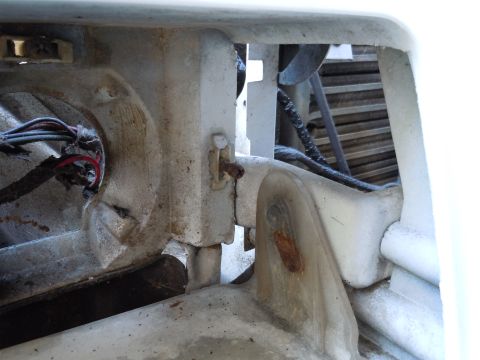 2001 Ford Crown Victoria - Detail of a corroded metal bracket and electrical wires on a vehicle component.