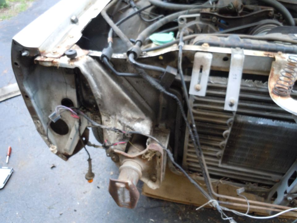 White 2001 Ford Crown Victoria front end with exposed engine components and damaged fender