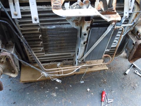 2001 Ford Crown Victoria - Close-up view of a vehicle's radiator and condenser assembly, showing various metal components and wiring.