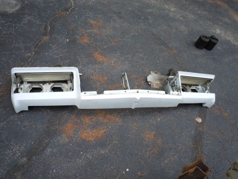 2001 Ford Crown Victoria - Front bumper assembly removed from a vehicle, showing internal mounting points and headlight recesses.