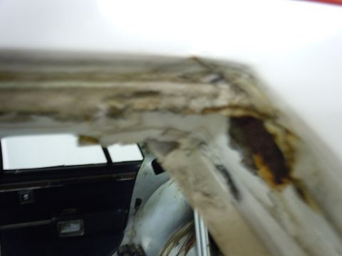 2001 Ford Crown Victoria - Close-up view of the interior of a vehicle, highlighting areas of rust and dirt accumulation.
