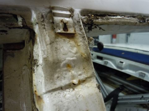 2001 Ford Crown Victoria - This image shows the interior of a vehicle, focusing on a corroded pillar and surrounding trim, with the door ajar.
