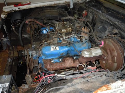 2001 Ford Crown Victoria - Engine bay components including a blue engine, carburetor, and brake booster are visible in this photo.