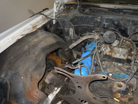 2001 Ford Crown Victoria - The engine bay shows a carburetor and blue valve covers, indicating a project in progress.