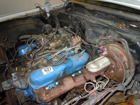 2001 Ford Crown Victoria - The engine bay of a vehicle, blue valve covers and visible exhaust manifolds.