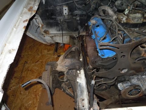 2001 Ford Crown Victoria - The engine compartment of a 2001 Ford Crown Victoria reveals its mechanical components and the vehicle's condition.