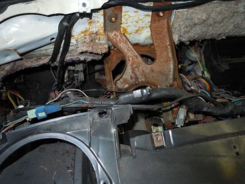 2001 Ford Crown Victoria - Exposed wiring and rusted metal parts are visible in the interior of a vehicle.