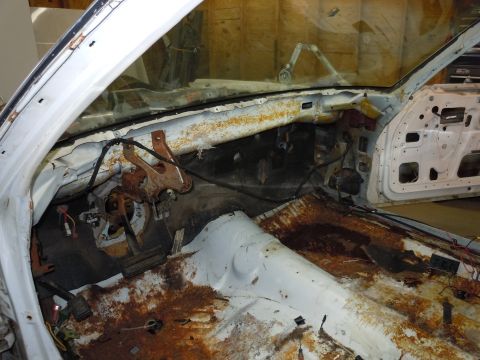 2001 Ford Crown Victoria - Interior view of a 2001 Ford Crown Victoria showing extensive rust and missing components.