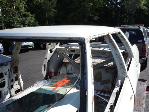 2001 Ford Crown Victoria - Stripped 2001 Ford Crown Victoria interior reveals frame and rust damage.
