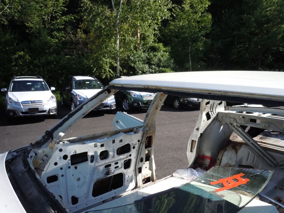 stripped car interior, other cars parked behind