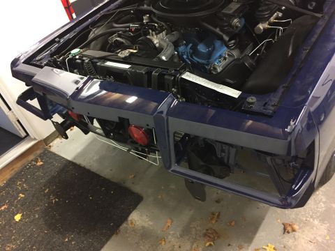 2001 Ford Crown Victoria - Front view of a dark blue car with its hood open, revealing the engine and partially disassembled front end.