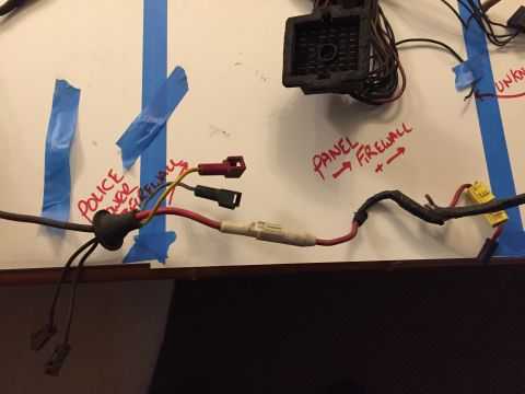 2001 Ford Crown Victoria - A wiring harness is laid out on a surface, with handwritten labels indicating 'POLICE POWER' and 'PANEL -> FIREWALL'.