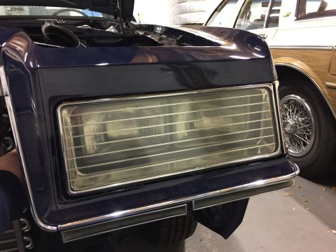 2001 Ford Crown Victoria - Close-up of a car's front end, with another vehicle partially visible beside it.