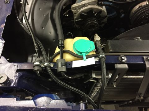 2001 Ford Crown Victoria - Close-up of engine bay components including alternator and coolant reservoir.