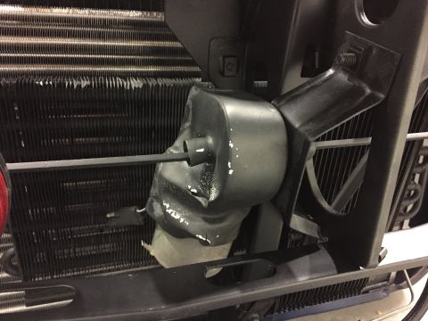 2001 Ford Crown Victoria - The radiator fan shroud appears to be damaged, with white paint specks on its surface.