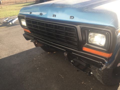 1979 Ford Bronco - Front view of a blue 1978 Ford Bronco, showing its grille and bumper details.