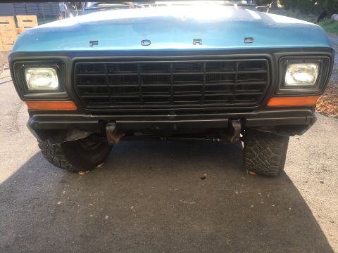 1979 Ford Bronco - Front view of a blue 1979 Ford Bronco, its distinctive grille and headlights.